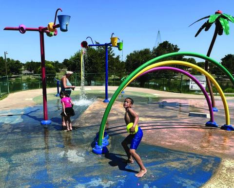 Mike W. Ray | Southwest Ledger Veronica Lawrence of Chickasha joins Kravitz Lawrence and Lillian Lake in cooling off at the Shannon Springs Park splash pad Aug. 10, 2023. The Chickasha City Council awarded a $53,900 contract recently to RJE Enterprises of Rogers, Arkansas, to rehabilitate the splash pad, which was built in 2007. “We’re just fixing what’s broken,” because replacing the entire facility would be much more expensive, Parks and Recreation Director Spencer Winzenried said.