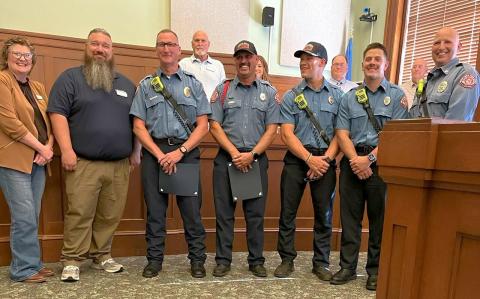 Photo courtesy of George Plummer The Chickasha City Council honored five firefighters recently for a swift-water rescue of a stranded man and his dog. Councilwoman Georgianne Hebblethwaite, left, read a heartfelt testimonial, and Mayor Zach Grayson, second from left, presented “Above and Beyond” citations to Captain Mike Peek and firefighter Travis Triplett, who were assisted in the rescue by driver Blair Smith, firefighter Tanner Croskey and firefighter Cameron Masters.
