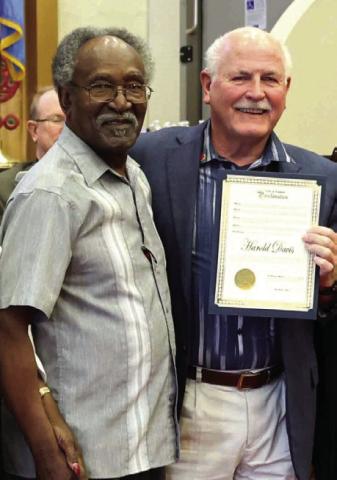 Harold Davis, left, receives his Citizen of the Month proclamation from Lawton Mayor Stan Booker. City of Lawton