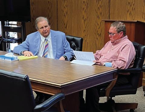 Comanche County District 1 Commissioner John D. O’Brien, right, confers with his defense attorney, John Zelbst, in a courtroom on March 13. Mike W. Ray | Southwest Ledger