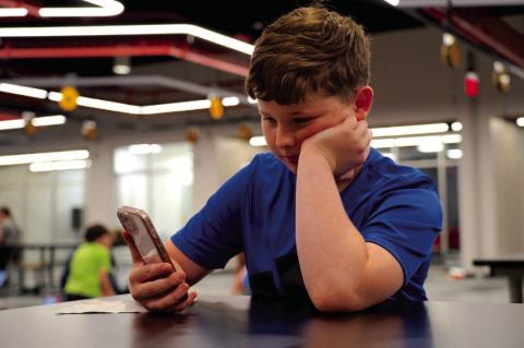 Eleven-year-old Nathan Barber does some research on the internet on a cellphone. Last week, Gov. Kevin Stitt signed House Bill 1276, which makes permanent the state’s yearlong test prohibition on students using cellphones and other non-school-issued electronic devices during the school day. Ashley Payne | Southwest Ledger