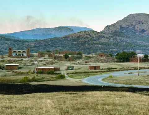 JJ Francais | Southwest Ledger Smoke plumes rise in the distance of the scorched earth near to the Holy City of the Wichitas in the Wichita Mountains Wildlife Refuge Oct. 26. Firefighters were able to extinguish the flames and spare the sacred site. Thousands visit the Holy City’s annual Prince of Peace Easter Pageant which retells the life, death and resurrection of Jesus Christ. The Holy City’s centennial performance is scheduled for the Saturdays before Palm Sunday and Easter Sunday 2025.
