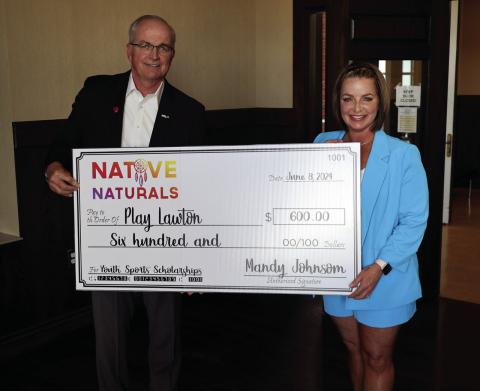 From the left, Lawton Youth Sports Authority Chairman Brian Henry and Mandy Johnson of Fierce Fitness are shown with a replica of a $600 check, which was presented to the authority during its June 13 meeting. The authority accepted the donation on behalf of PlayOn, the nonprofit component of PlayLawton. City of Lawton